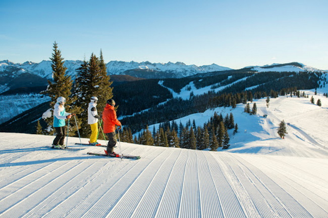 Group skiing groomed terrain in Vail, Colorado.